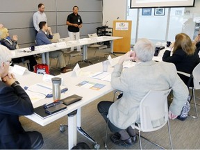 Public health inspector Aptie Sookoo, standing at background right, and program manager Bill Sherlock, standing at left, explain the latest data on Lyme disease to members of the Hastings and Prince Edward Counties Board of Health Wednesday, June 6, 2018 in Belleville, Ont. Lyme disease is now considered endemic in Prince Edward County and in Hastings County south of Highway 7. Luke Hendry/Belleville Intelligencer/Postmedia Network