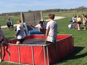 Students dove into a pool at the finish line of the Dirty Bird obstacle course at Peninsula Shores District School in Wiarton on May 18. Submitted photo