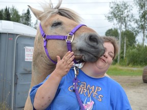Program mentor Cheryl Bruce gets a kiss from a horse at Verdiel Farms in Hanmer, home to the Whinnying in Life program. (Jim Moodie/Sudbury Star)