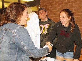 Northern Secondary School teacher Nicole Cartwright checks out the T-shirts offered by Chari-Tees, Wednesday, at West Ferris Secondary School, with help from Logan Burk and Alexandra Murmilo. The showcase sponsored by the Learning Partnership got students from six schools in the area to come up with their own business ideas, with proceeds supporting local charities. Chari-Tees is providing funds to Community Living West Nipissing.
PJ Wilson/The Nugget