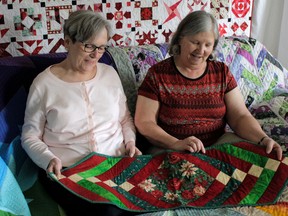 KINGSTON, Ont. Limestone Guild President Susan Clarke (left) and Limestone and Heirloom Guild member Simone Lynch (right) show quilts that will be on display at the Quilts Kingston show from June 8, to June 10, 2018.
Wyatt Brooks for The Whig-Standard/