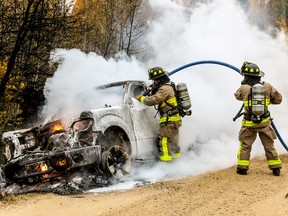 Wetaskiwin firefighters work to put out a vehicle fire near Coal Lake Oct. 1. (Sarah O. Swenson/Wetaskiwin Times)