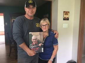 Joe and June Winchester hold a picture of their father and husband, John Dawson Winchester, who died last year at the age of 87 from cancer. The family is organizing a golf tournament in his memory with proceeds going to the Canadian Cancer Society. (Laura Broadley/Times-Journal)