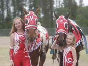 (Left to right) Kensie Herben and Sawyer Lacey smile for the camera prior to one of their performances at the Grande Prairie Stompede last Friday. The two young girls have formed a partnership called Flying Stride Trick Riding.