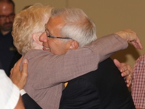 Vic Fedeli gets a congratulatory hug after winning Nipissing Riding in Thursday's provincial election. Fedeli said the PC majority government will build a "path to prosperity" for Northern Ontario. 
PJ Wilson/The Nugget