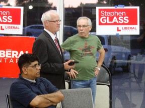 Liberal candidate Stephen Glass watches election results roll in Thursday with supporters at his campaign office.