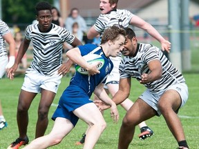 Quinte (blue) vs. Newmarket Denison in opening-round action Thursday at the OFSAA AA boys rugby championships at MAS Park. (Don Carr photo)