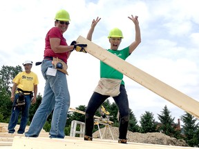 The latest Habitat for Humanity Chatham-Kent home build is taking shape in Pain Court, Ont. Volunteer Lil Cragg, front left, and Cindy Krutasky, whose family is buying the home, have a little fun on Thursday, June 7, 2018, while work was done to frame the walls. Darrell Shadd, construction supervisor of the project, is pictured in back. (Handout)