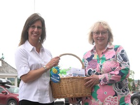The Welcome Wagon's Erica Oseen and Jennifer Foy hold one of their baskets presented to Cochrane newcomers.