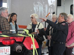 Harold Phillips gives some area seniors a tour of Cochrane Fire's facilities during Seniors' Week Monday.