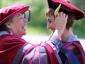 Chancellor Shirley Horn adjusts the regalia of Algoma University president Asima Vezina following her investiture ceremony at Bishop Fauquier Memorial Chapel on Friday.