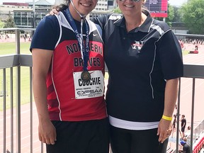 Brent Couchie, left, poses with coach Nicole Cartwright after winning OFSAA gold in the midget boys javelin event in Toronto, Friday. Kaitlyn Fitzpatrick Photo