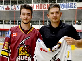 Timmins Rock coach Corey Beer and forward Riley Brousseau hold the 2001-birth-year forward’s white road jersey. The Rock officially announced on Friday that Brousseau, who played seven regular season games and 13 more in the playoffs as an affiliate player, has signed to play for them in 2018-19. He joins former Timmins Majors teammate Austin Holmes and defenceman Carson Burlington on the roster.  THOMAS PERRY/THE DAILY PRESS