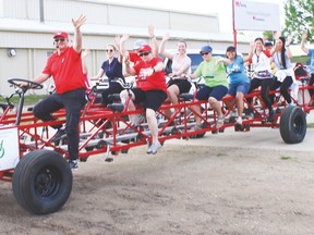 Local participants in the Heart and Stroke Foundation Big Bike ride wave as they depart from the parking lot outside the Cultural-Recreation Centre May 24. This was the 25th year local residents have taken part in the fundraiser. Jasmine O’Halloran Vulcan Advocate