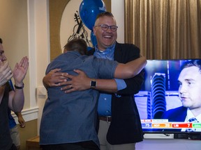PC candidate Will Bouma receives a hug and standing ovation Thursday night from party supporters after winning Brantford-Brant.  (Alex Vialette/The Expositor)