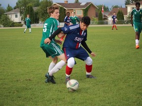 Tate Trueman attempts to fight off an FC Sting defender.