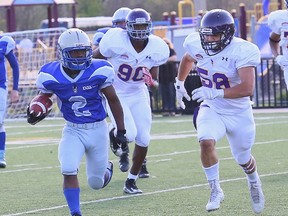 Alex Lockhart, left, of the Sudbury Gladiators, is chased by Scarborough Thunder players during varsity football action at the James Jerome Sports Complex on Saturday. John Lappa/Sudbury Star