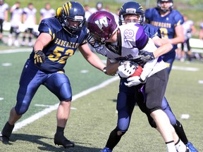 Two Sault Sabercats close in on a Waterloo Predators player during third-quarter Ontario Football Conference action on Saturday at Superior Heights Collegiate and Vocational School. Waterloo won 8-7. The junior varsity Sault Sabercats downed Waterloo 22-13. Nick Pagnotta had 17 carries for 260 yards and three touchdowns. Tyler Brechin threw for 117 yards and ran for 38 yards. Ethan Fawcett had two interceptions. " It was a good effort by the boys today,” said coach Jim Monico in an email. “(They) bounced back nicely from last week and increased the intensity.”