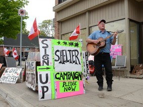 Ray Botten plays his guitar on the street along 2nd Ave. E. near the former site of the Victorious Living Centre emergency shelter on Saturday. (Rob Gowan The Sun Times)