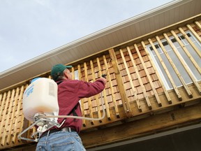 Robert Maxwell/For The Sudbury Star
One-time, water-based treatments are the fastest and easiest way to improve the colour of outdoor wood. Here Steve sprays Eco Wood Treatment onto a pressure-treated deck and railing.