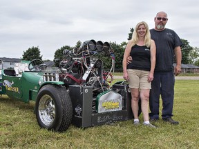 Barb and Rod Cochrane of Newcastle, ON, stand beside their 3,000 horsepower pulling truck as they prepare to compete in a Super Pull event on Saturday at the fairgrounds in Paris. The couple, who both have vehicles they drive in pull events, travel the circuit across the province during the summer months. 
Brian Thompson/The Expositor