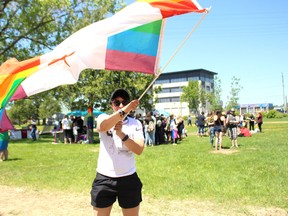 Renee Stuber waves her Canadian rainbow flag during Fierté Timmins Pride at Hollinger Park on Saturday, June 9 in Timmins. A parade made it's way downtown at 3 p.m.
