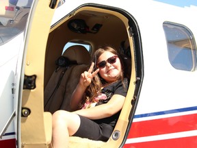 Makenna Mayer smiles as she sits in an airplane at Young Eagles Day at Victor M. Power Airport on Saturday, June 9 in Timmins. About 200 children visited the venue, learning about different aircrafts and viewing the city while in an airplane in the sky.