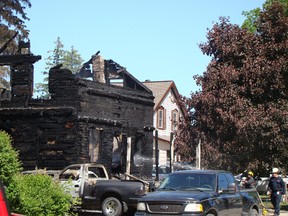 Firefighters continue to hose down the remains of a home that burned in Chesley Monday morning. Three people remained unaccounted for, police said.
(Derek Lester/Postmedia News)