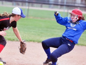 Randi Shuker (right) of the MDHS varsity girls slo-pitch team slides in safely to third base during semi-final action against South Huron, a 15-10 win. ANDY BADER/MITCHELL ADVOCATE