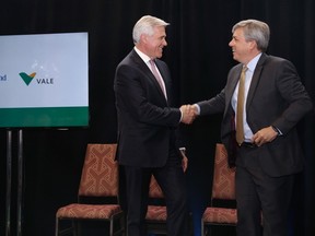 Newfoundland and Labrador Premier Dwight Ball, left, and Eduardo Bartolomeo, Vale executive director, base metals shake hands after an announcement in St. John's on Monday, June 11, 2018, that construction of the Voisey's Bay underground mine will proceed this summer. THE CANADIAN PRESS/Paul Daly