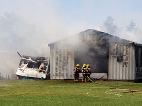 Norfolk firefighters battled an aggressive blaze in this outbuilding on McDowell Road West near Langton Monday afternoon. The fire is not considered suspicious. The building and its contents were destroyed, with damage estimated at $300,000. Norfolk Fire & Rescue photo