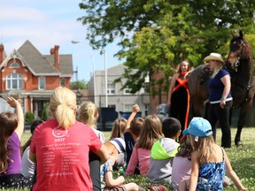 Mackenzie Vollans and Brittnee Brett of Off-Kilter Entertainment answer questions about their horse, Bayou, for students at St. Joseph Catholic Elementary School in Chatham on Tuesday to promote the rodeo coming to Pain Court on June 29. The event is a key fundraiser for Chatham-Kent Crime Stoppers. (Fallon Hewitt/The Daily News)