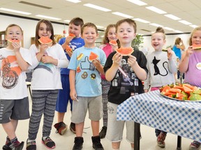 Students munch on fruits and veggies at London's Woodland Heights Public School, one of many schools participating in the region's Ontario Student Nutrition Program, designed to give in-need students a healthy option to start the day. Students include, from left, Jacob Tangen, Kayla Morris, Thomas McGregor, Kaden Hadley, Olivia Horne, Periden Brockett, Chloe Cook, and Hannah Curtis. (Louis Pin/Times-Journal)