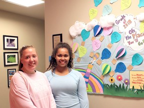 Brigid Goulem/For The Whig-Standard
Tanisha Fetterly and Erica Saunders are seen in front of their graduation bulletin board at the Pathways to Education offices as they prepared to graduate last Friday.