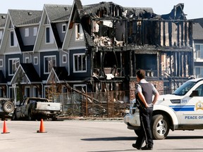 Cochrane fire investigate a early morning condo fire under construction and nearby homes that were damaged by the heat in Cochrane on Wednesday, June 6.