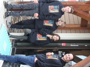 Logan Jensen (from left to right), Joelan Bruce, Esmee Kabonik and Joshua Clarke stand out front of The Shoe Closet with their first ramp to be installed.