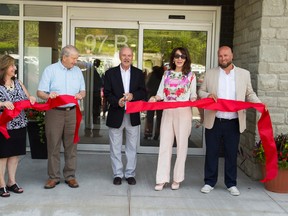 Maryellen Maclellan (left),Brantford housing director, Brant Mayor Ron Eddy, Brantford Coun. John Sless, Josephine Atanas, Brantford GM of health and human services, and Jeff Lowe,Brantford housing development co-ordinator, help cut the ribbon during the grand opening Tuesday of the John Noble Apartments on Mount Pleasant Street. (Alex Vialette/The Expositor)