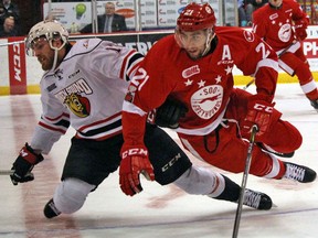 Sault Ste. Marie Greyhounds defenceman Conor Timmins (right) and Owen Sound Attack centre Brett McKenzie mix it up during first-period OHL playoff action Thursday evening at Essar Centre. JEFFREY OUGLER/SAULT STAR/POSTMEDIA NETWORK