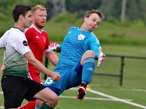 Stratford Bentley’s City FC keeper Kyle Buxton and teammate Mattias Wienecke (middle) watch as a ball is narrowly deflected past the net by a Windsor SC Fury player Sunday during the Ontario Cup Masters Provincial Championships match in Stratford. City FC won 4-0. (Cory Smith/The Beacon Herald)