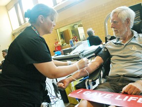 Angela O'Brien, a donor care associate with Canadian Blood Services, draws Paul Van Hardeveld's blood for his 200th donation at a blood clinic at the Spirit and Life Centre - St. Joe's Site on Wellington Street West in Chatham Wednesday. (Tom Morrison/Postmedia Network)