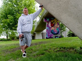 London artist Brad Biederman stands near one of his murals under the overpass connecting the London Convention Centre to the Double Tree by Hilton. Biederman said he was simply looking for an interesting canvas when he approached the convention centre for permission to pain there last year. This weekend, a three-day street art festival will include Biederman and other Canadian artists.
