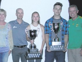 Canmore Collegiate's Amanda Graham (centre) and George Reed pose with their top athlete awards flanked by Kay and Gary Anderson, sponsors of the award, and high school athletic director Darren Anderson on Thursday.