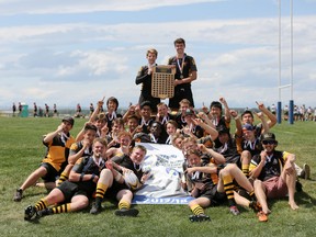 Daniel Dixon, centre, leads the charge against The Strathcona Tweedsmuir Spartans during the provincial rugby championships on in Calgary. Dixon, scored two tries during the match, to help secure the gold medal.