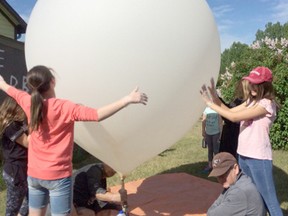 A group of students descended in Hanna on June 4 after releasing a balloon from Airdrie. The balloon was expected to land in Delia, however made its way to an island on Fox Lake instead.