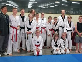On Saturday, June 9, students from Joe Kim Tae Kwon Do and Phoenix Performance Taekwondo engaged in a grueling four hour black belt examination at the Mount Forest Curling Club. Front, left to right: Avery Vallance, Patrick Reid, Charlie Reid. Back, left to right: Grand Master Joe Kim, Remington Dosman, Brad Armstrong, Victoria Topic, Pete Forsey, Tyson Brooks, Nancy Smith, Damien Hytle, Jamie Reeves, Andrew Rogers, Joey Townsend, Breckin Lachance, Greta Dearing, Master Dave Reeves