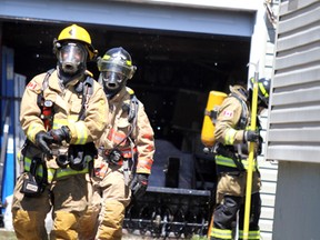 Firefighters respond to a blaze at a detached garage at 100 Eastern Ave., on Thursday.