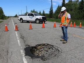 Public Works supervisor Mario Vandal inspected the sinkhole on Laforest Road caused by a culvert collapse.
 LEN GILLIS / Postmedia Network