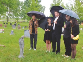 The cast and crew of Abracadavers were in Nanton May 31 to shoot a scene for the web-based series. The production, made up of emerging artists, is shooting throughout Alberta, as well as some locations in British Columbia. In this scene, the character Chris, played by Griffin Cork, middle, visits the grave of his mom, who died in a freak hair salon chair accident. From left in the photo are Franco Correa, Emma Houghton, Cork, Jordan Wright and Courtney Charnock. Stephen Tipper Nanton News