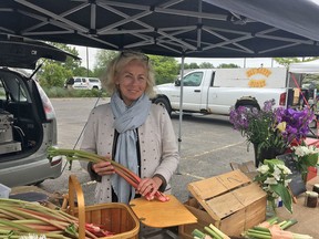 Ruthie Cummings, founder of the West Market, holds some rhubarb at her vendor tent, which offers a collection of sourdough breads in all varieties and sizes and local wild foods on Saturday June 2 2018. Sebastian Bron/The Whig-Standard