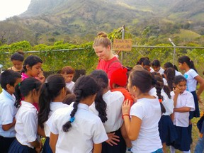 On a recent mission trip to Nicaragua, a group of area residents decided to raise $5,000 on their return to Canada to help a community kitchen in Managua purchase a proper oven. Pictured, Elly Schreuders, one of the youth that participated in the mission trip, meets a group of local girls who attend the school next door to the community kitchen. (Submitted photo)